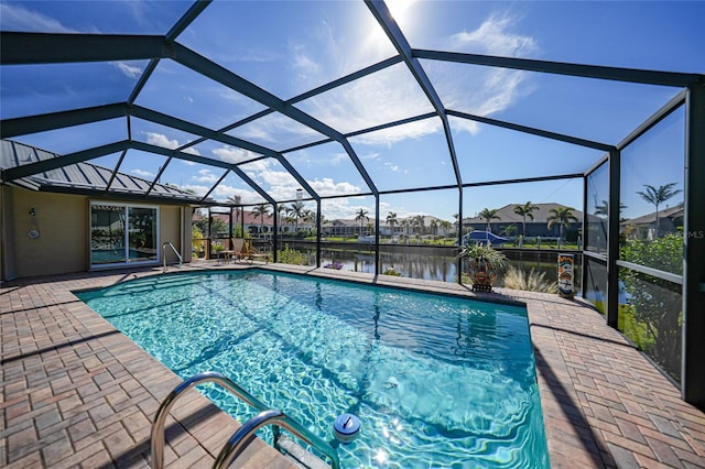 view of swimming pool featuring a water view, a lanai, and a patio