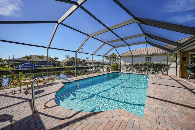 view of swimming pool with a water view, a patio area, and glass enclosure