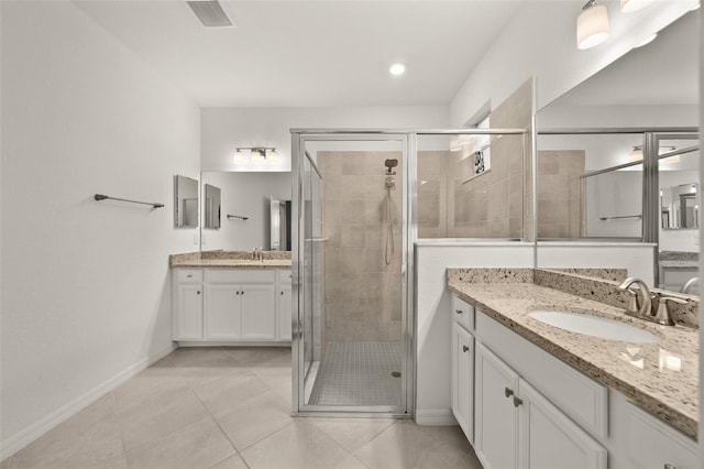 bathroom with vanity, an enclosed shower, and tile patterned floors