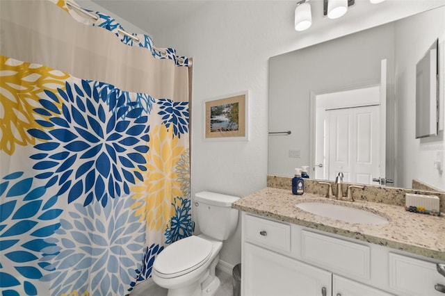 bathroom featuring vanity and toilet