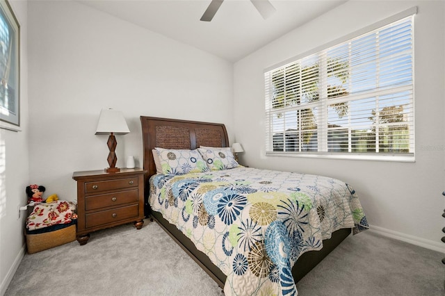 carpeted bedroom with ceiling fan and vaulted ceiling