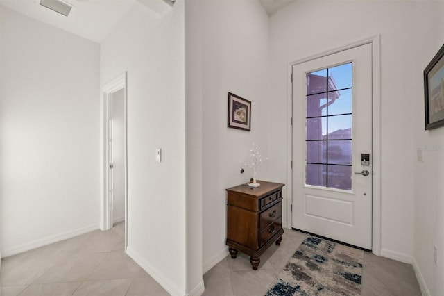 entryway with light tile patterned flooring