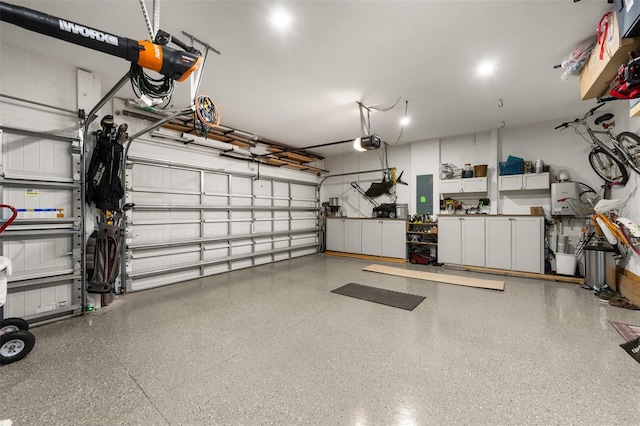 garage with a garage door opener and electric panel