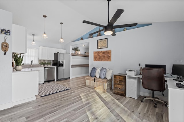 office featuring ceiling fan, high vaulted ceiling, sink, and light hardwood / wood-style floors