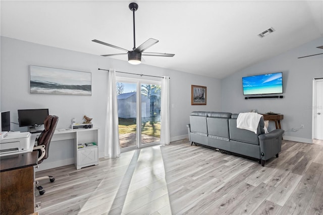 living room featuring vaulted ceiling, ceiling fan, and light wood-type flooring