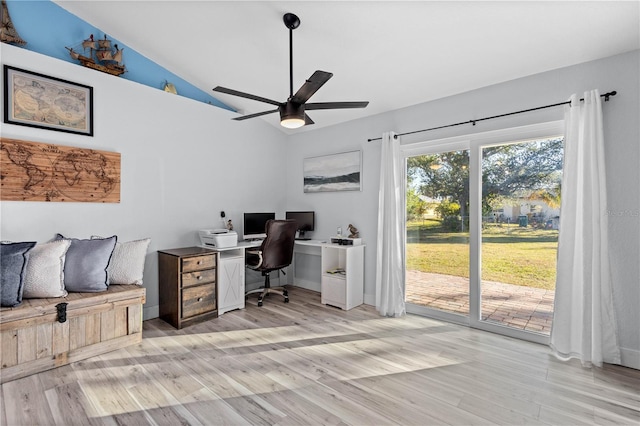 office featuring ceiling fan, vaulted ceiling, and light wood-type flooring