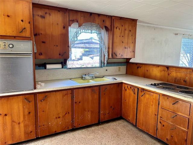 kitchen featuring sink, plenty of natural light, cooktop, and stainless steel oven