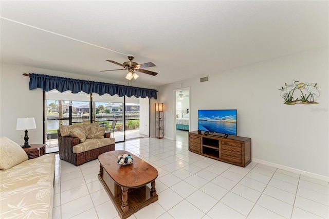 living room featuring ceiling fan and light tile patterned flooring