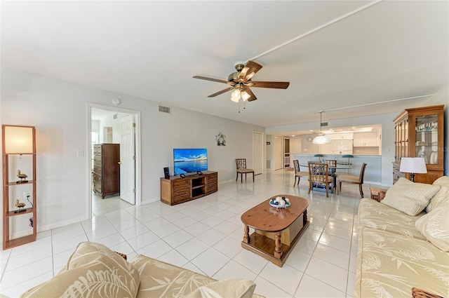 tiled living room featuring ceiling fan