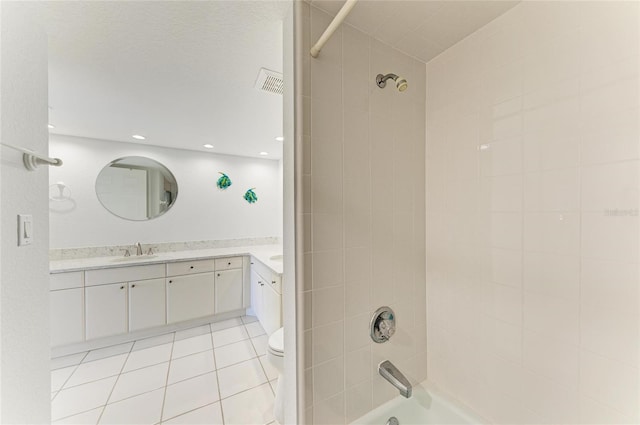 full bathroom with vanity, toilet, tiled shower / bath combo, and tile patterned flooring