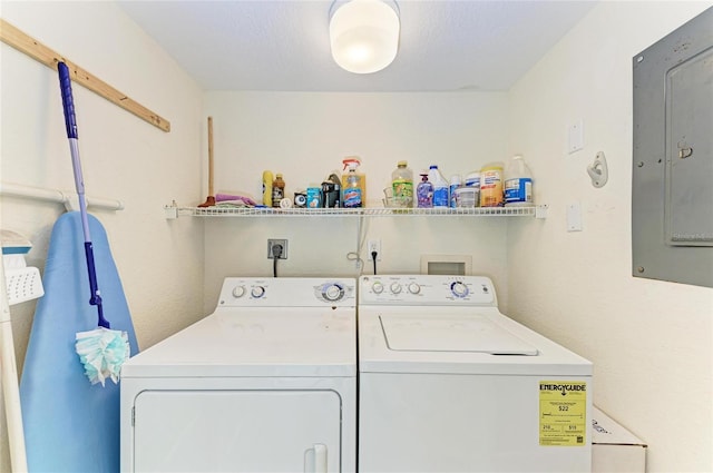 clothes washing area featuring electric panel and washer and dryer