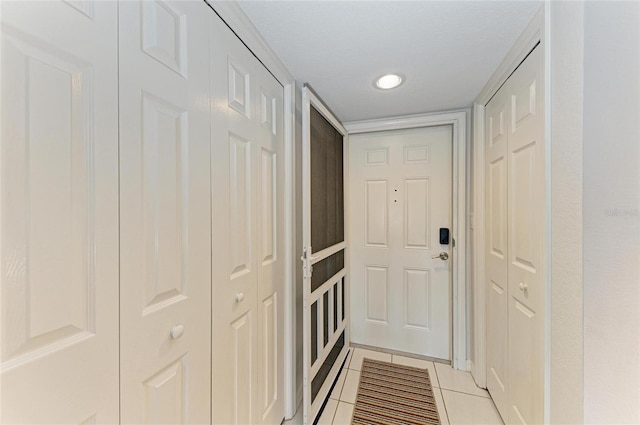 entryway with light tile patterned floors