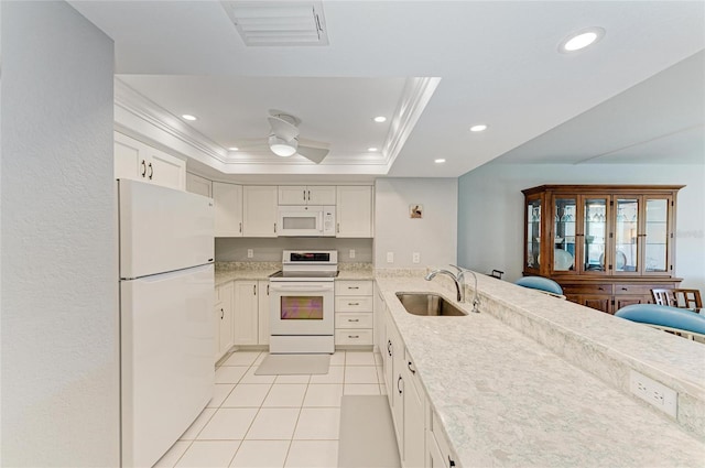 kitchen with sink, ornamental molding, a raised ceiling, white appliances, and white cabinets