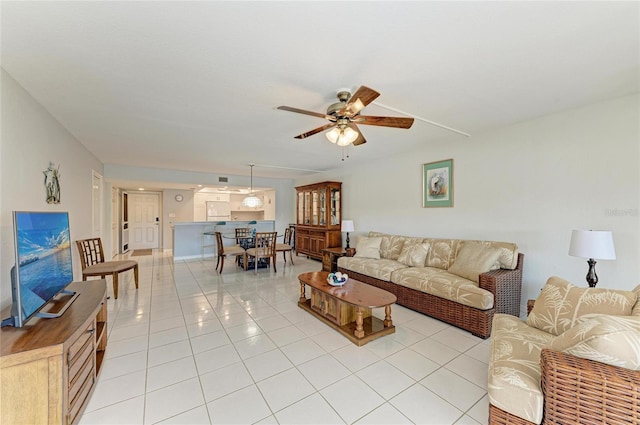 living room featuring ceiling fan and light tile patterned floors