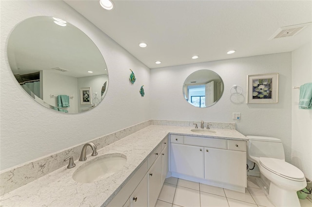 bathroom featuring tile patterned floors, vanity, and toilet