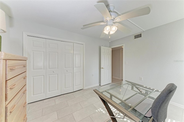 unfurnished bedroom featuring ceiling fan, a closet, and light tile patterned floors