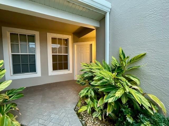 doorway to property with a patio