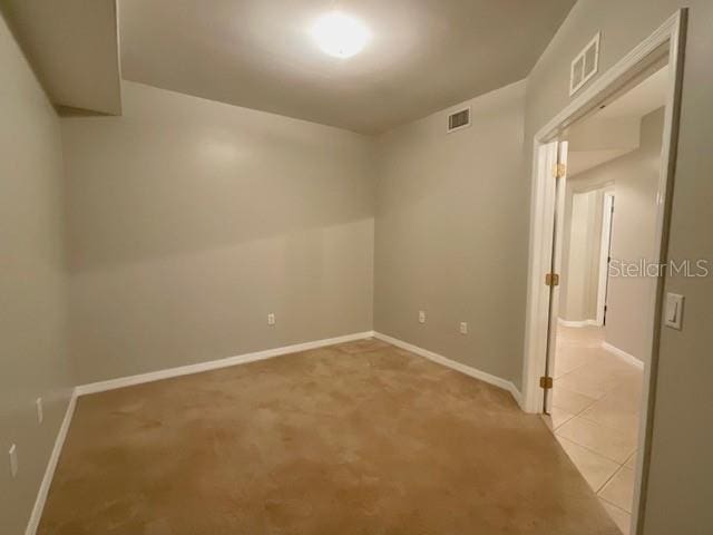 empty room featuring light colored carpet