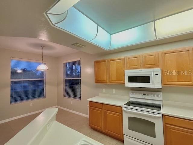 kitchen with white appliances and decorative light fixtures