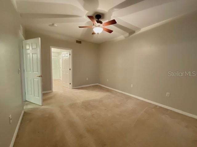 spare room featuring ceiling fan and light colored carpet