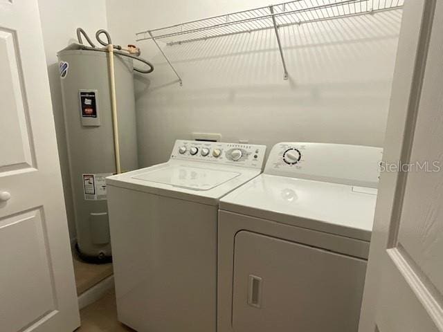 laundry room featuring independent washer and dryer and electric water heater