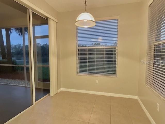 tiled empty room with a wealth of natural light