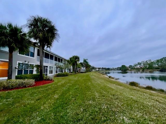 exterior space with a water view and a yard