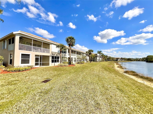 view of community with a lawn and a water view