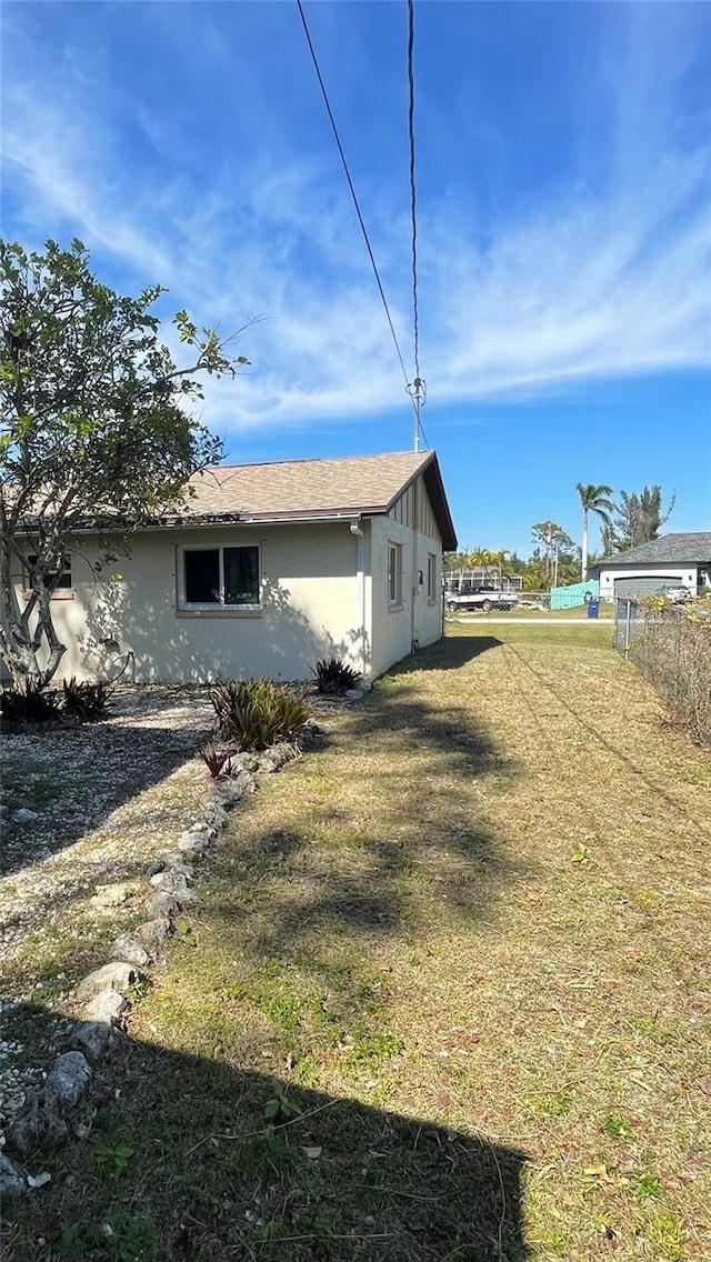 view of side of home with a lawn