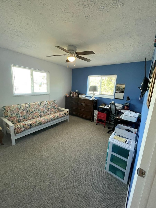 carpeted bedroom featuring a textured ceiling and ceiling fan