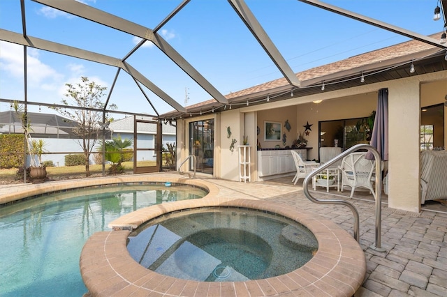 view of pool featuring an in ground hot tub, a lanai, and a patio