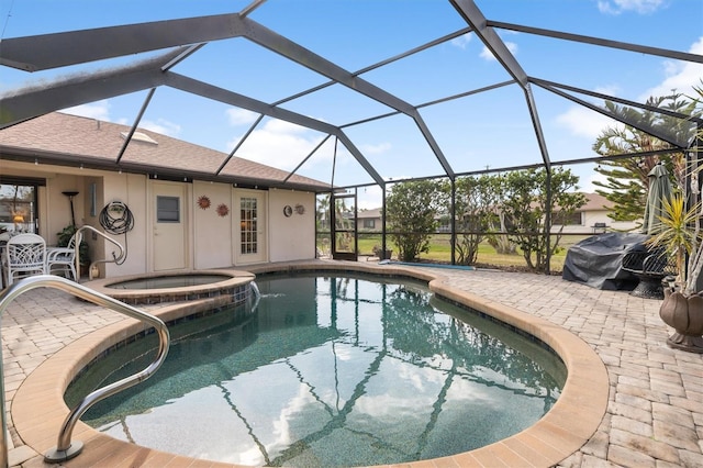 view of swimming pool featuring grilling area, an in ground hot tub, glass enclosure, and a patio area