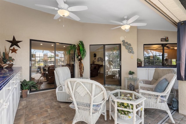 interior space with ceiling fan