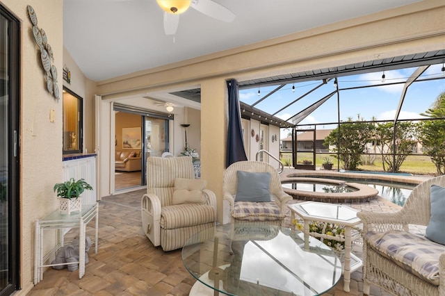 sunroom / solarium featuring ceiling fan