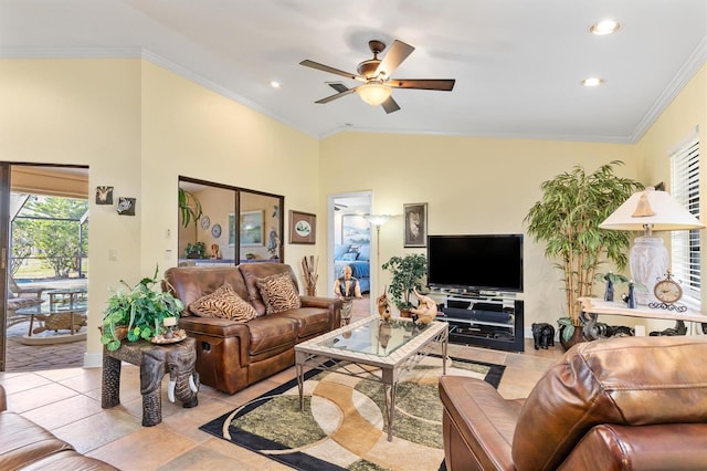 living room featuring ceiling fan, ornamental molding, lofted ceiling, and light tile patterned floors