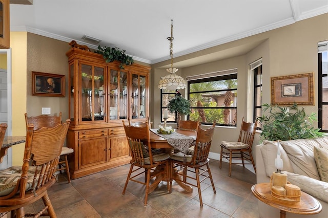 dining space with ornamental molding