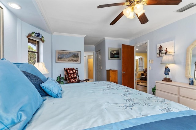 bedroom featuring ornamental molding, a closet, and ceiling fan