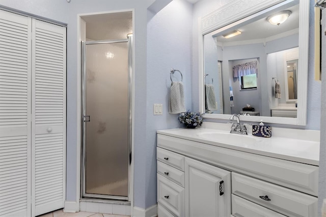 bathroom featuring vanity, a shower with shower door, and ornamental molding