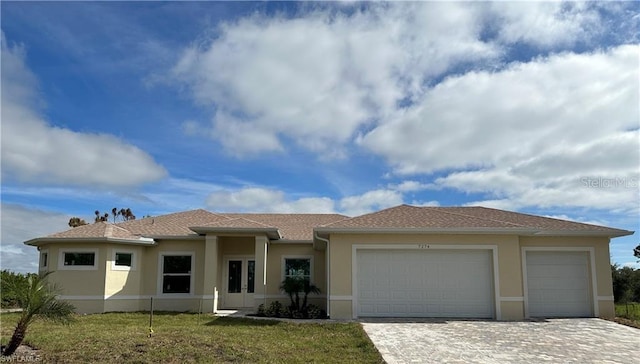 view of front of property featuring a garage and a front lawn