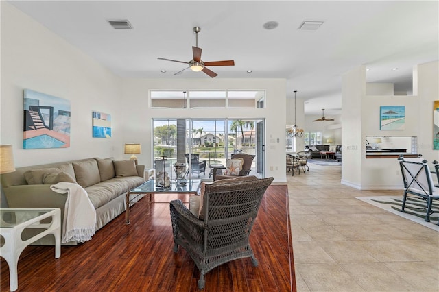 tiled living room with ceiling fan