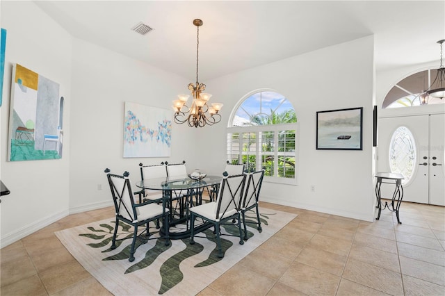 tiled dining room featuring an inviting chandelier