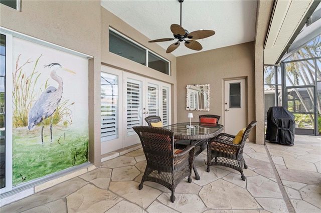 sunroom featuring ceiling fan