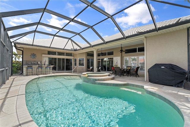 view of pool with an in ground hot tub, a lanai, an outdoor bar, ceiling fan, and a patio area