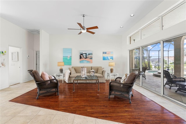 tiled living room with a towering ceiling and ceiling fan