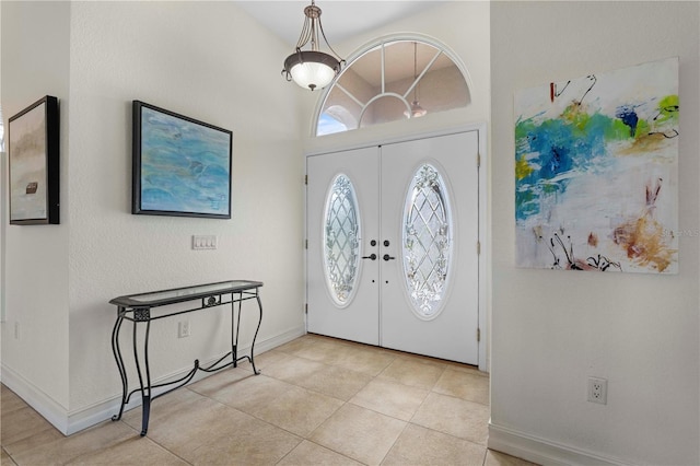 entryway featuring french doors and light tile patterned floors