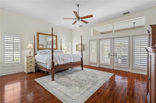 bedroom with multiple windows, dark wood-type flooring, access to outside, and french doors