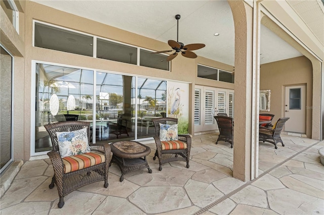 sunroom with ceiling fan and vaulted ceiling