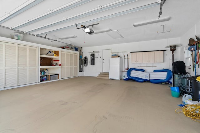 garage featuring a garage door opener and white fridge