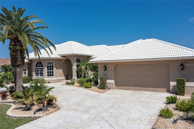 mediterranean / spanish-style house with a garage