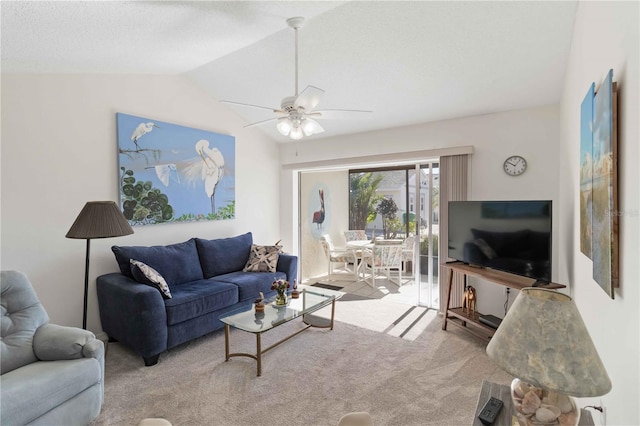 carpeted living room featuring vaulted ceiling and ceiling fan